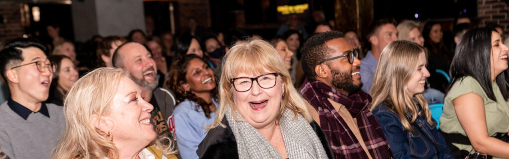 Lady laughing into the camera at Kings of Comedy club